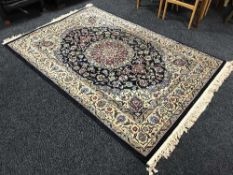 A fringed woollen Tabriz rug on blue ground