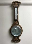 A carved oak barometer