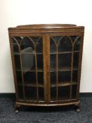A double door display cabinet on claw & ball feet