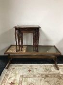 A teak tiled and glass top table and a nest of tables