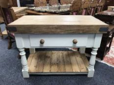 A reclaimed pine butcher's block, fitted with a drawer, on a painted base, with undershelf,