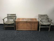 A teak garden storage box and pair of armchairs
