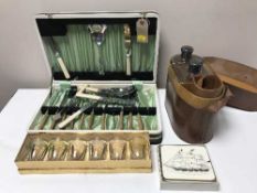 A leather travel case containing decanter, flask and glasses, cased set of cutlery,