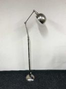A chrome angle poise floor lamp