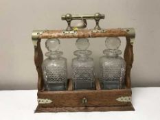 An oak three decanter Tantalus