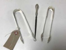 Two pairs of silver sugar tongs and a silver handled button hook