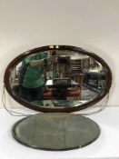 A Victorian mahogany oval mirror and an un-framed mirror