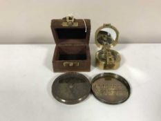 A brass compass in a mahogany box and a brass compass by Gilbert
