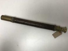 An antique brass telescope by E.