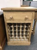 A reclaimed pine bottle rack, fitted with a drawer above, width 61 cm.