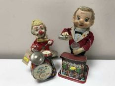 A tin plate battery operated bar tender and a tin plate clown playing the drums