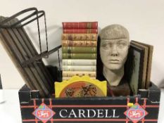 A box of framed pictures, pottery head sculpture, wooden paper rack,