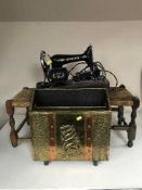 A Singer sewing machine together with two oak rush seated stools and a copper and brass magazine