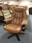 A brown leather swivel relaxer armchair