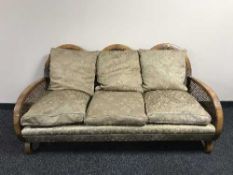 A three piece walnut bergere lounge suite