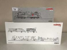 A Marklin 37431 diesel locomotive together with a 48802 transfer train car set (HO Scale),