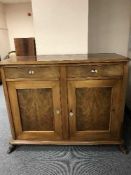 A mahogany and walnut double door sideboard
