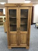 An antique pine glazed door bookcase
