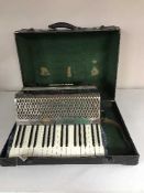 A cased Hohner Carmen II piano accordian