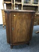 A mahogany corner cupboard