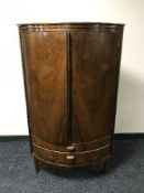 A walnut double door corner cabinet