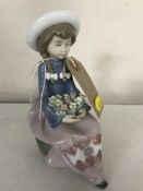 A Lladro figure - girl with flowers numbered 5554