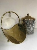 A brass coal bucket with lid and a brass log basket