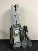 A rogue golf bag containing a set of clubs together with five assorted tennis and badminton rackets