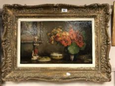 Alfred Joseph Auguste Van Neste (Belgian 1874-1969) : Still life with flowers in a vase next to a