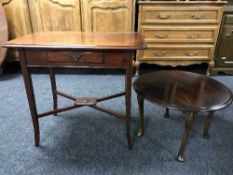 A circular walnut coffee table and a side table