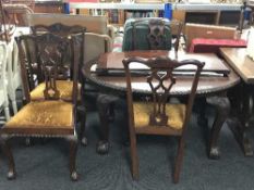 A Victorian mahogany wind out dining table with leaf and hand together with four Victorian dining
