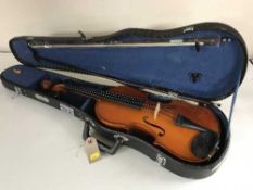 A Sky Lark violin and bow in coffin case and a music book