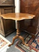 A shaped oak tripod table