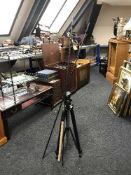 A camera tripod together with a three piece carbon fishing rod with extensions