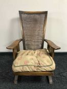 An early 20th century bergere backed armchair