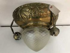 An early twentieth century brass light fitting with leaf decoration with opaque moulded glass shade