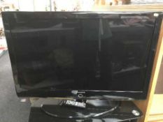 A Samsung 40 inch LCD tv with remote on stand