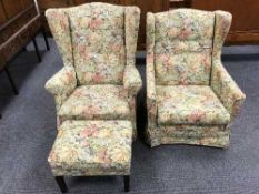 A pair of floral upholstered button back armchairs and a footstool