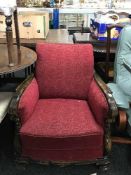 A heavily carved walnut framed lounge chair