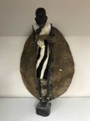 A carved figure - African tribesman together with a hide upholstered shield