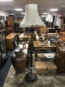 A mahogany standard lamp with shade