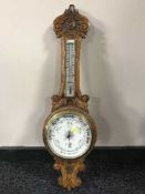 A carved oak banjo barometer