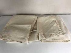 A pair of cream floral lined curtains,