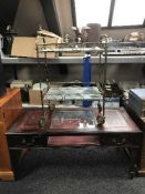 A mahogany leather topped curio table fitted with two drawers together with a mid twentieth century