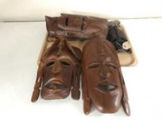 A tray of eight tribal masks together with a hardwood carving