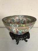 A 19th century Chinese Canton Famille Rose punch bowl, on wooden stand.