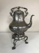 A large plated teapot on stand with burner
