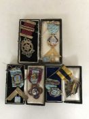 A collection of seven silver Freemasons medals.
