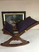 A mahogany gout stool together with a black and gilt framed oil on board depicting fish