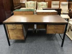 A mid 20th century teak and metal double pedestal desk